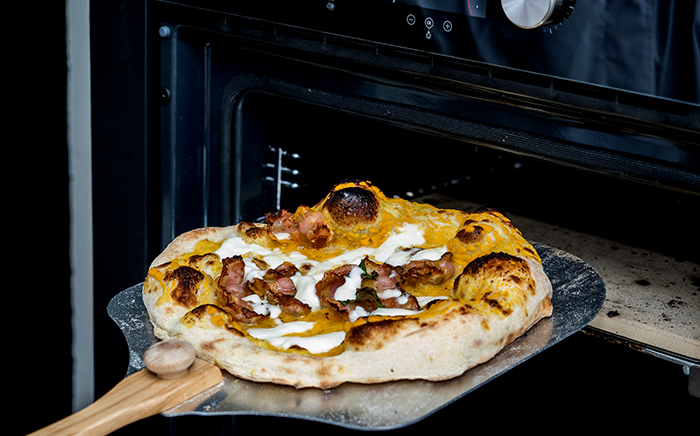 pizza napolitana saliendo horno con una pala de pizza