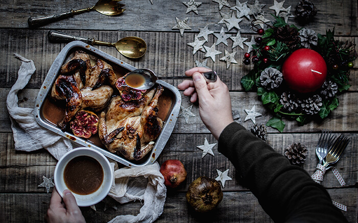 Oven tray with chicken on a Christmas decorated table