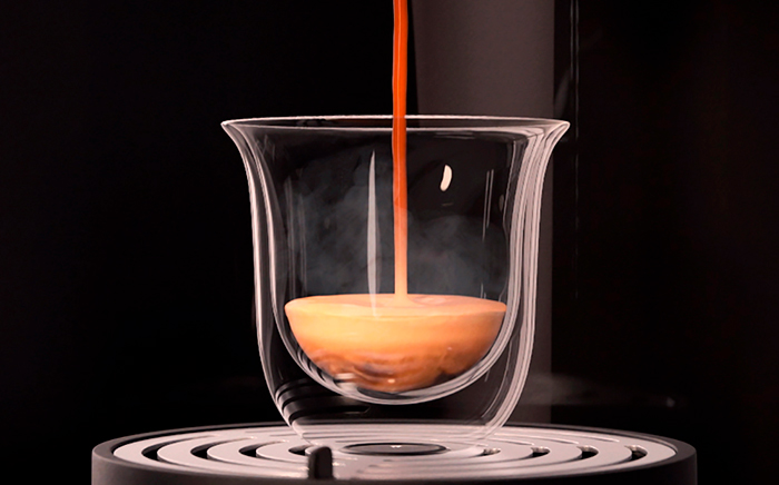 Glass with freshly brewed coffee on a coffee maker