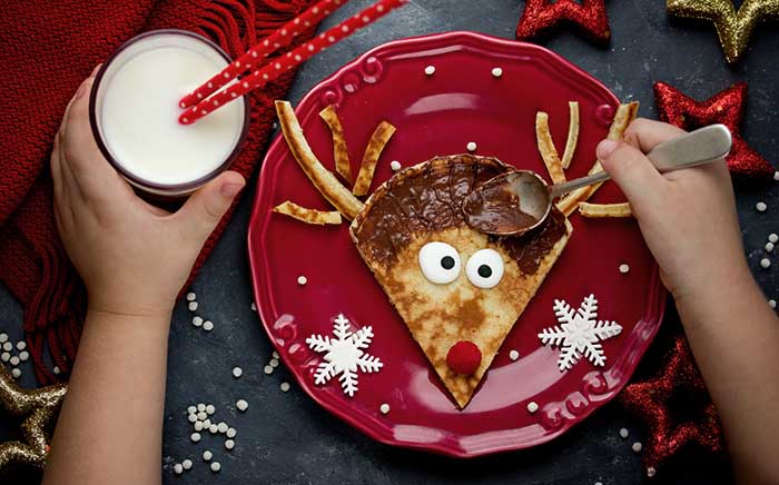 Plate with Rudolph pancake and milk ready to eat for children 