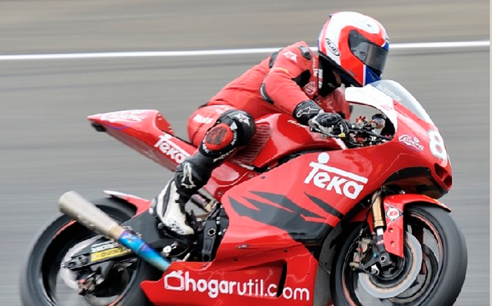 Motorcycle with a member of Teka team with a full Teka sponsorship equipment