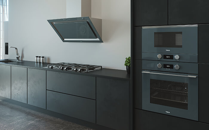 Built-in Teka appliances where black hood, microwave, oven and hob can be seen