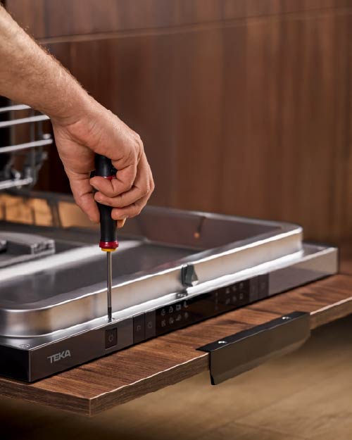 teka customer service spare parts, man working on a dishwasher