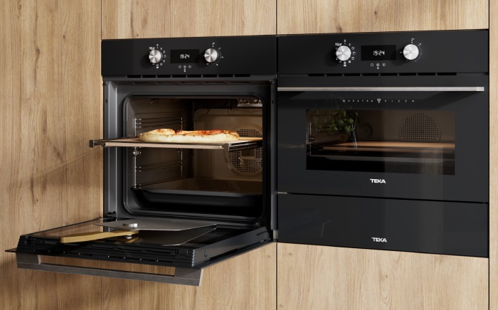 MaestroPizza ovens by Teka in black, one of them open showing a home-made, fresh pizza
