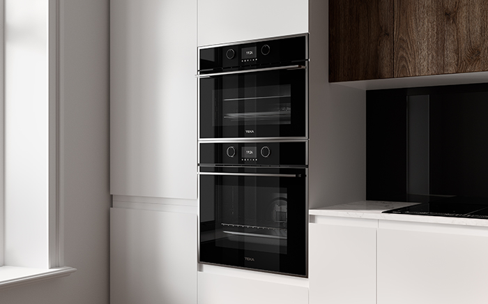 Black oven and microwave by Teka in column in a white kitchen