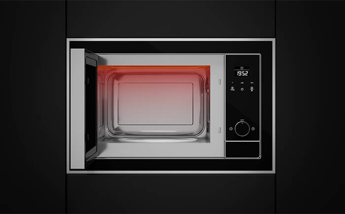 A built-in microwave oven with its door open, interior illuminated with red light, and digital clock display showing 8:52.