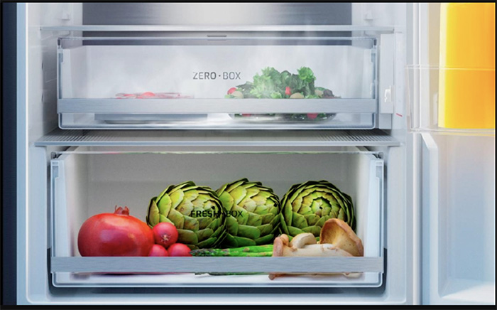Close-up ZeroBox and FreshBox drawers inside a Teka fridge freezer with greens inside