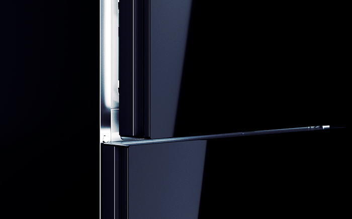 A black freezer door half open with light inside