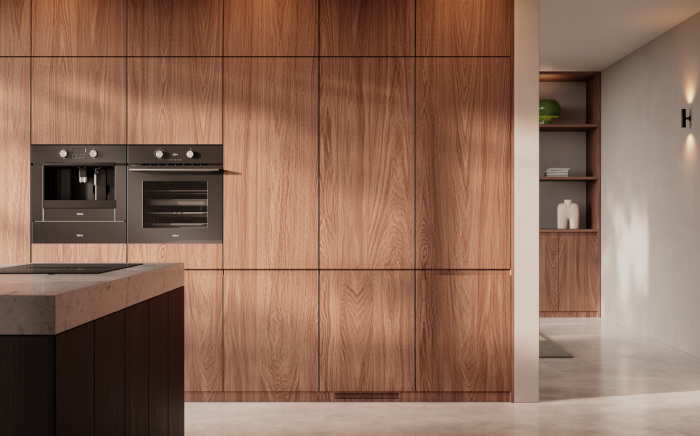 Seamless modern kitchen featuring concealed, panel-ready built-in appliances integrated into rich, warm-toned wood cabinets.