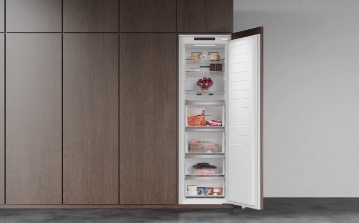 Open Teka built-in Max single-door upright freezer with multiple storage drawers, integrated into dark wood kitchen cabinetry.