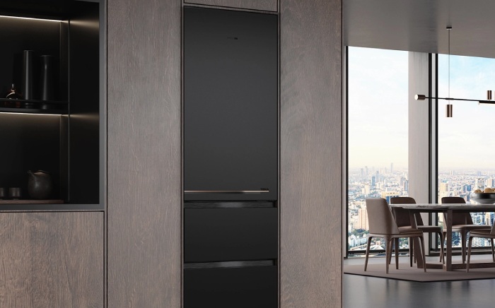 Slot-in In-Line Teka refrigerator built seamlessly into dark wood kitchen cabinetry, set against a modern high-rise city view.