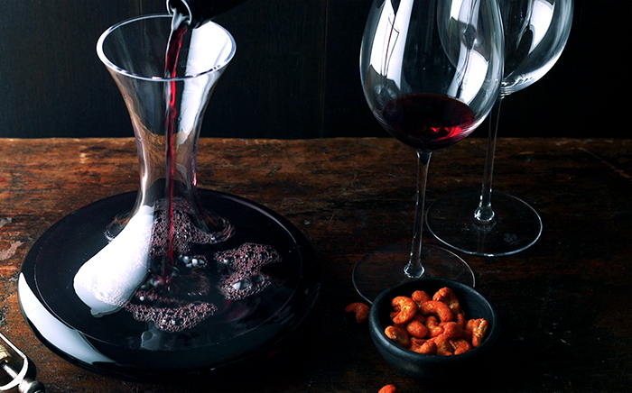 Glasses of red wine together with a typicall Spanish bottle of wine ready for serving