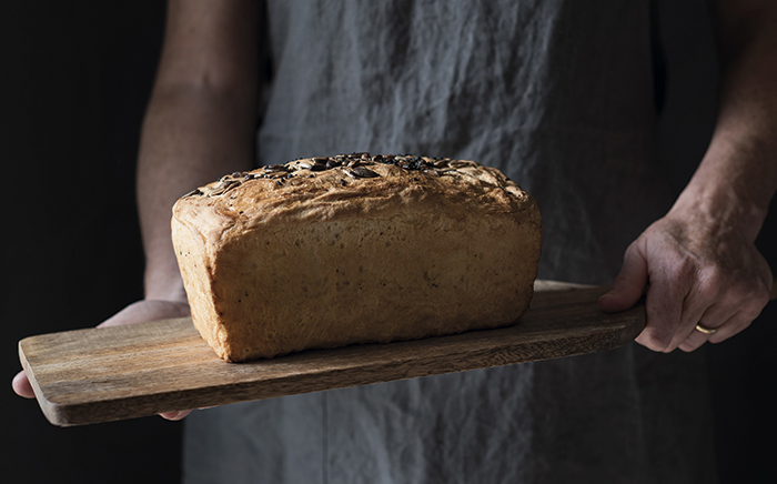 Bread with seeds on top served on a wooden board 