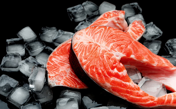 Two slices of salmon on ice