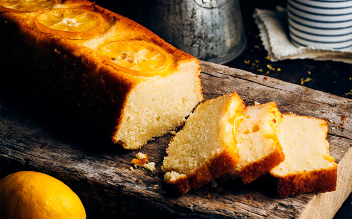 Fluffy lemon sponge cake with several slices already cut