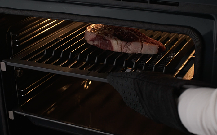 A thick steak on the grill rack of the SteakMaster oven by Teka