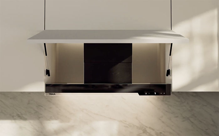 Integra by Teka integrated cooker hood in a white cabinet with open door