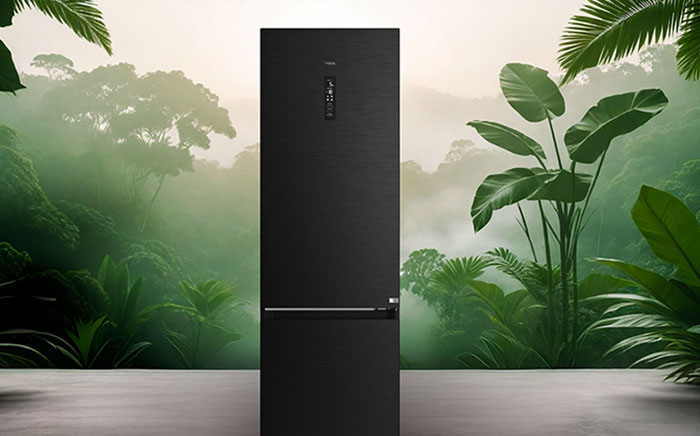 High energy efficient refrigerator by Teka, second generation, over a background with green plants